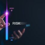 Businessperson adjusting a vertical risk level bar from low to high using a digital interface, symbolizing risk management and decision-making with SpeciCred